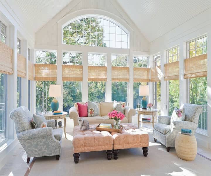 Bright and airy sunroom featuring a plush sofa, patterned chairs, surrounded by large windows that adds value to the property.