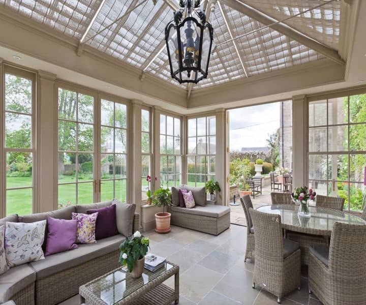 A bright sunroom featurestrendy interior, and large windows that maximises natural light.