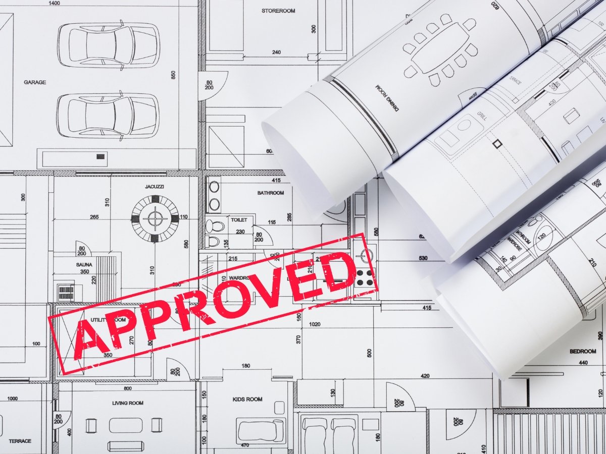 architectural drawings with a bold red "approved " text, presenting legal approval of the blueprints.